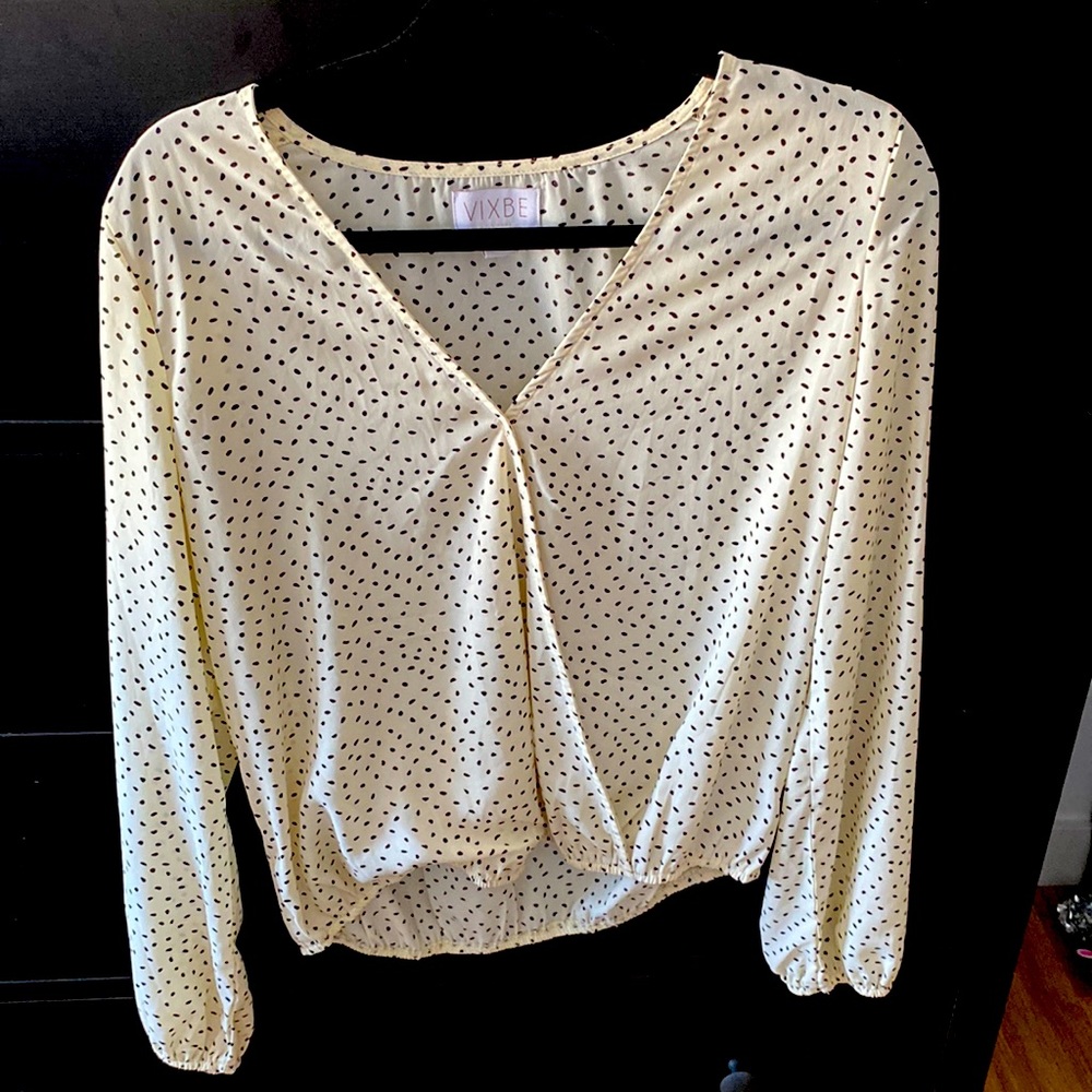 Cream colored business casual blouse with black polka dots
